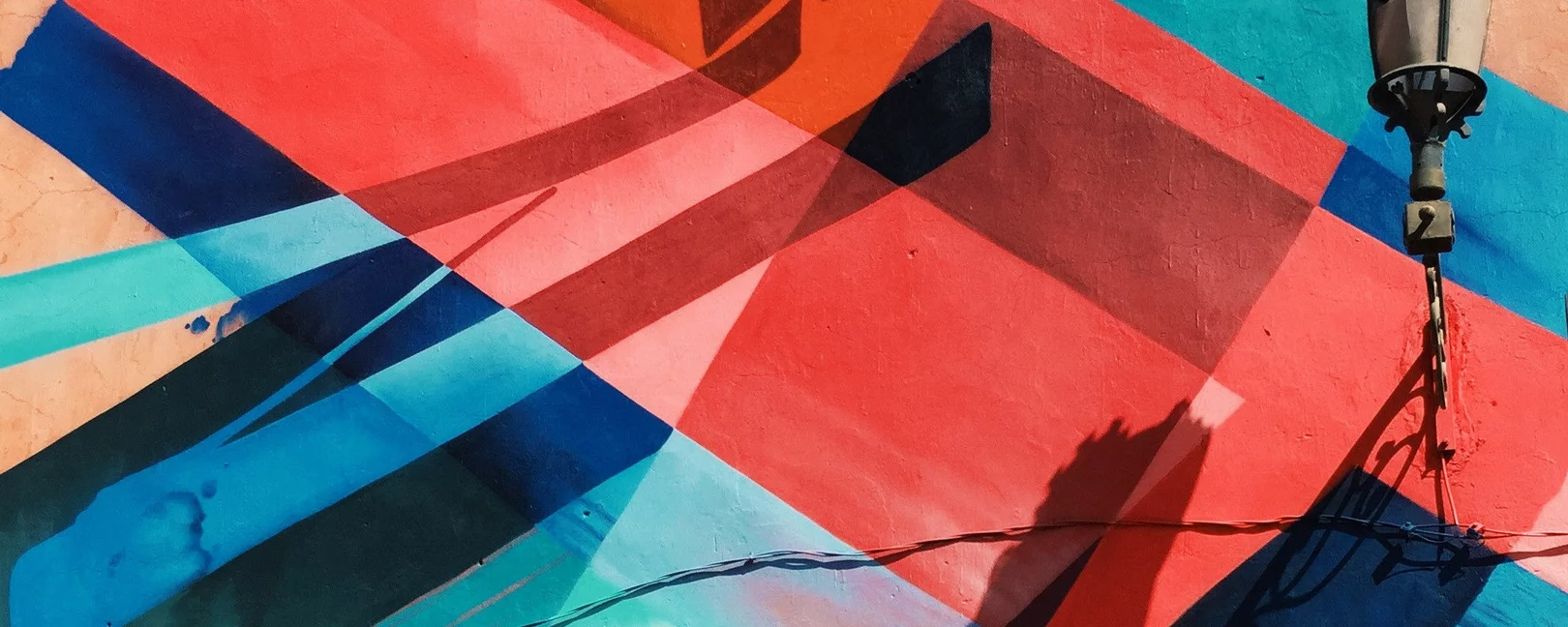 Man in front of abstract mural in Marrakesh